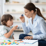 Child playing with therapist